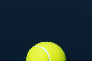 a navy back ground #122235 and a tennis ball in the forefront bottom left corner
